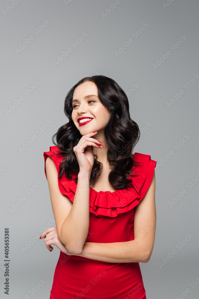 cheerful young woman with red lips looking away isolated on grey cheerful young woman with red lips looking away isolated on grey