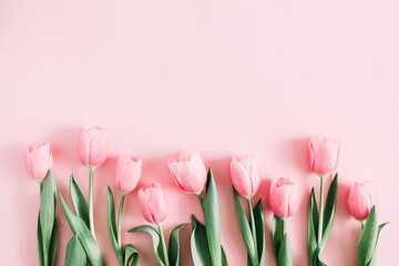 Beautiful composition spring flowers. Bouquet of pink tulips flowers on pastel pink background. Valentine's Day, Easter, Birthday, Happy Women's Day, Mother's Day. Flat lay, top view, copy space