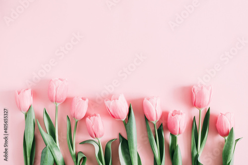 Beautiful composition spring flowers. Bouquet of pink tulips flowers on pastel pink background. Valentine's Day, Easter, Birthday, Happy Women's Day, Mother's Day. Flat lay, top view, copy space #405655327