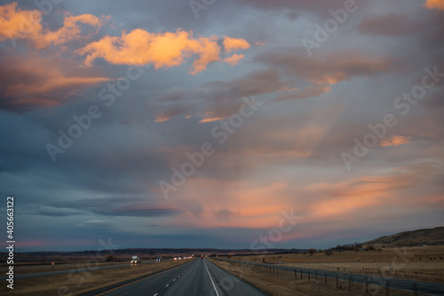 Beautiful sky at sunset dark blue and bright orange clouds over the highway © Liudmila