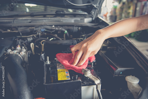 Hand with microfiber cloth cleaning engine car,cleaning car interior  photo