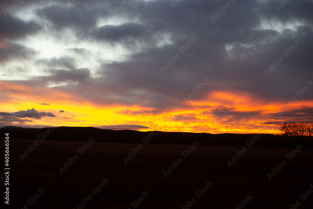 Fiery scenic sunset sky in blue and bright orange colors