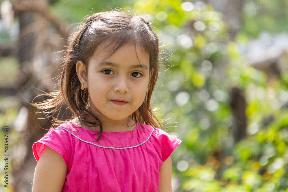 Girl in pink dress and little black eyes very expressive Girl in pink dress and little black eyes very expressive