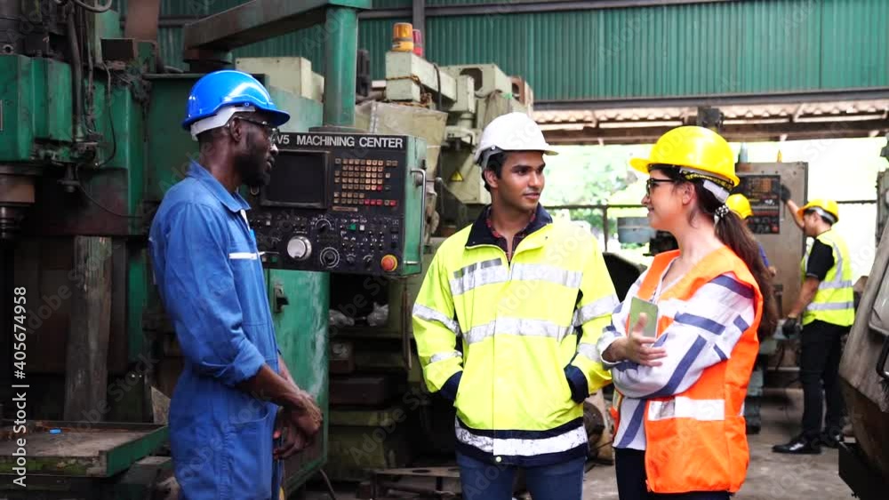 A group of technicians are discussing the operation of machines in large industrial plants. A group of technicians are discussing the operation of machines in large industrial plants.
