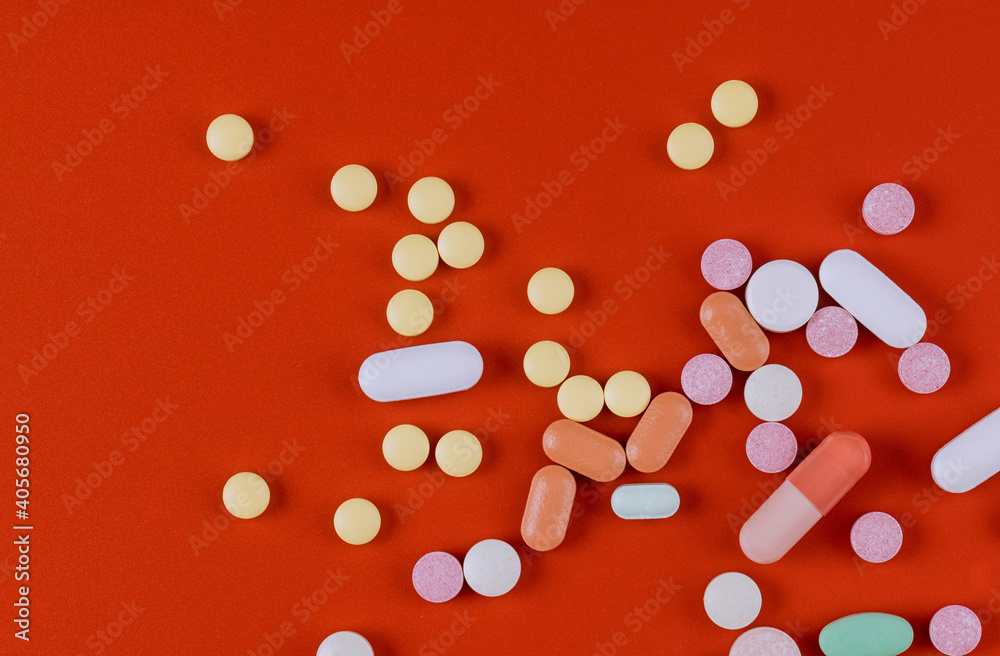 Drugs pills capsules treatment, disease hospital illness disease on bright red background