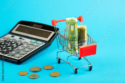 Shopping cart with euro, calculator. Finance concept.