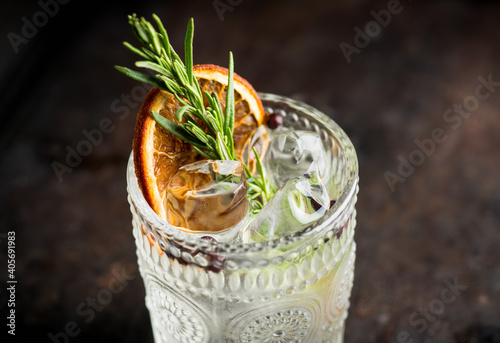 Old fasioned gin based cocktail with triple sec on the rustic background. Selective focus. Shallow depth of field. photo