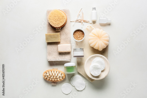 Composition with bath accessories and cosmetics on light background