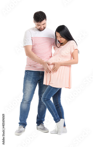 Young pregnant couple on white background © Pixel-Shot