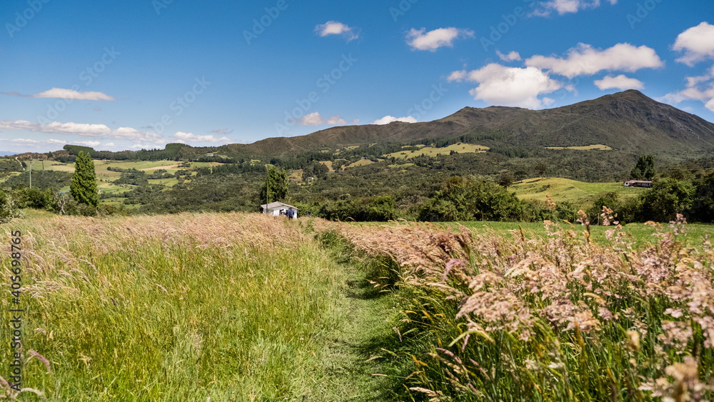 Obraz premium landscape with mountains and sky with clouds view of the valley of the mountains hills road to the mountains exotic landscape adventure mountains blue sky escape wild rural landscape