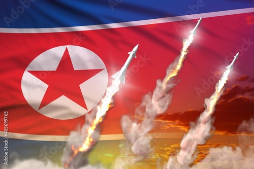 North Korea ballistic missile launch - modern strategic nuclear rocket weapons concept on sunset background, military industrial 3D illustration with flag photo