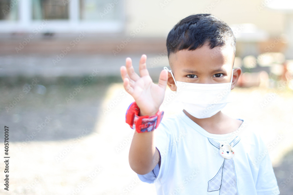 Plakat Asia boy wearing facial mask for protect corona virus and air pollution pm2.5 with blurred background. Wuhan coronavirus. Covid-19, pm2.5 and health care concept.
