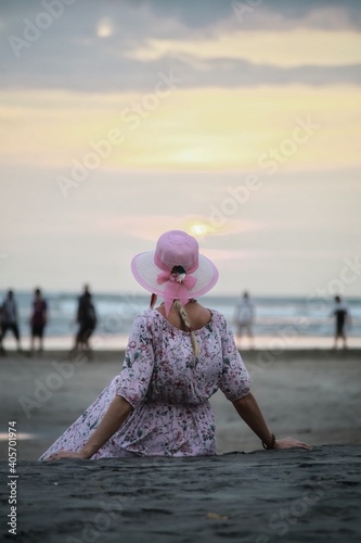 A girl in a pink dress and a pink hat