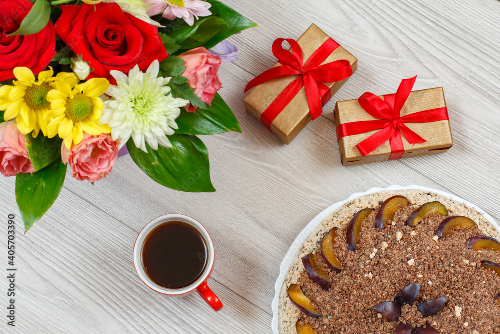Chocolate cake decorated with plums and cup of coffee Chocolate cake decorated with plums and cup of coffee