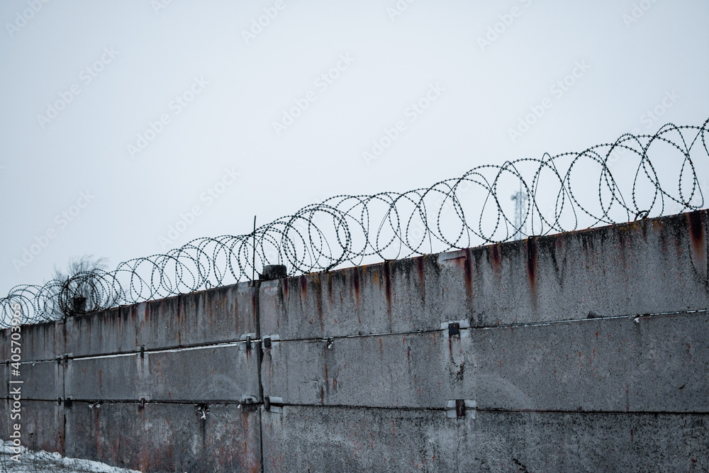 A concrete fence. Barbed wire. restricted area. High quality photo