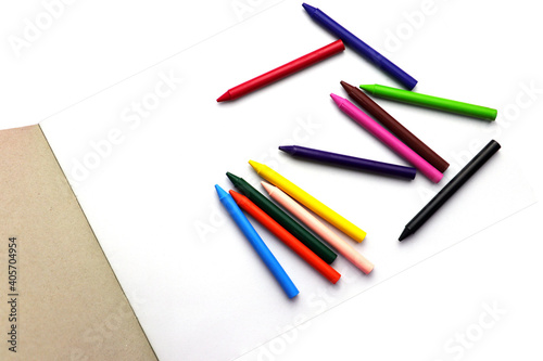 crayons and drawing book on withe background.