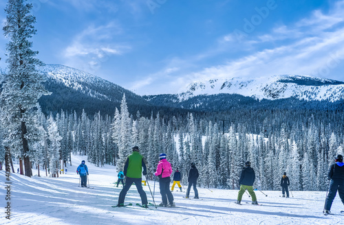 People skiing in the mountains in Colorado ski resort on nice winter day