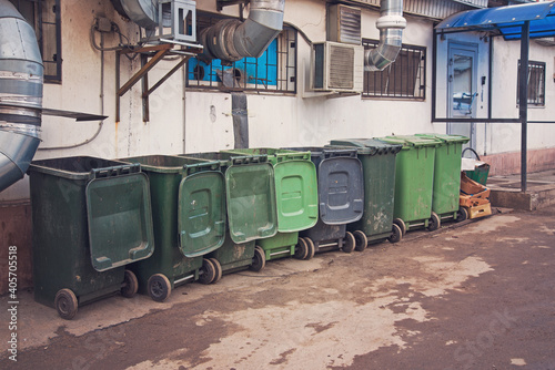 a row of green dumpsters