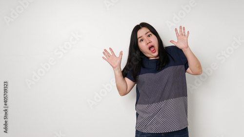 Portrait of amazed young woman over white background. Looking at camera.