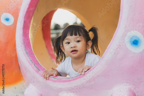 Portrait image of 2-3 years old of toddler baby girl. Happy Asian child playing with the toy at the park playground. Learning and kid concept.