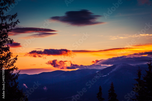 Fototapeta Naklejka Na Ścianę i Meble -  Beautiful dawn in the winter snow-covered mountains and amazingly beautiful clouds
