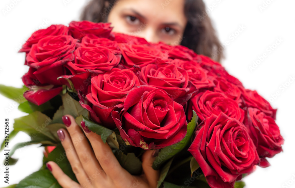 Girl with a bouquet of red roses isolated on a white