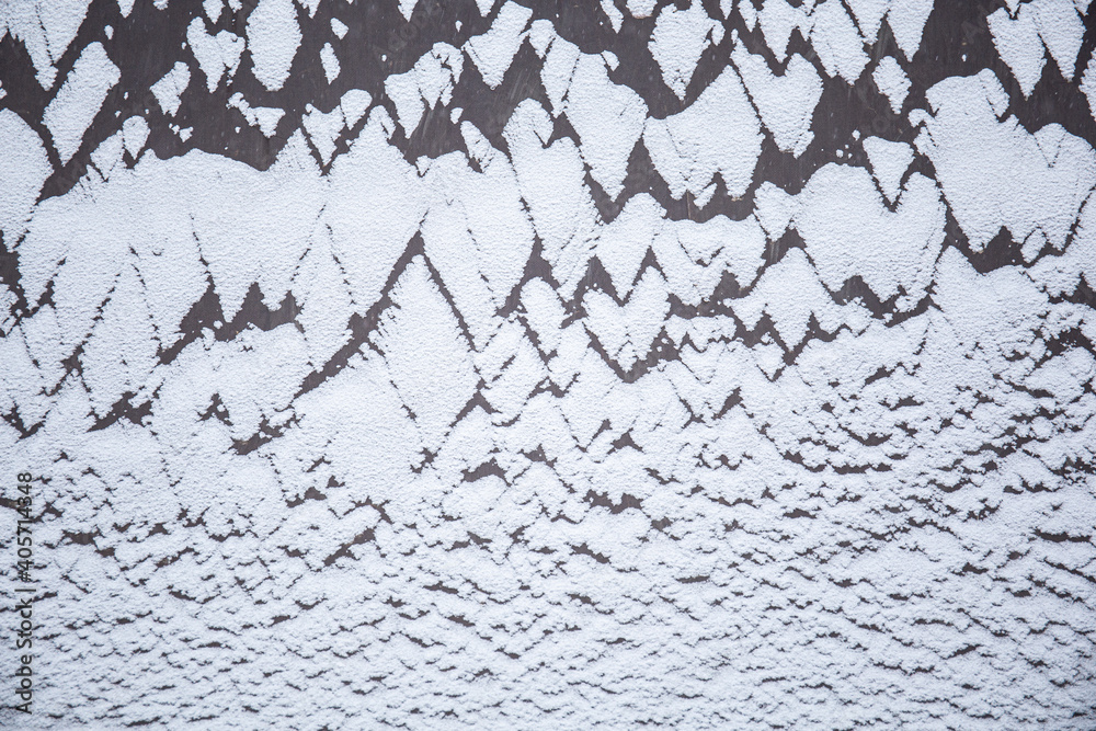 Snow texture on a dark surface. Winter background
