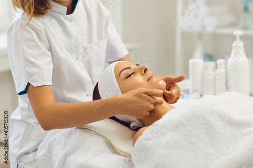 Obraz na plátně Therapist making professional manual relaxing massage for young woman with finge