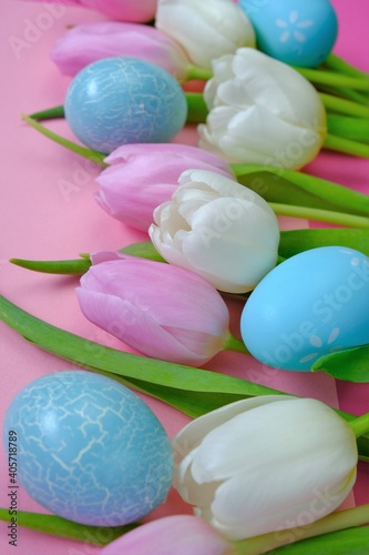 Easter holiday. White and pink tulips flowers,blue easter eggs  set on a pink background.Easter  eggs and spring flowers in pastel colors set.Spring festive easter background.Easter symbol.