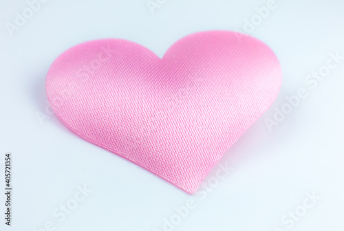 Pink heart on white background. Saint Valentine's day concept. Love and romantic photo. Postcard for holiday. Beautiful warm wallpaper with love. Soft focus. Copy space.