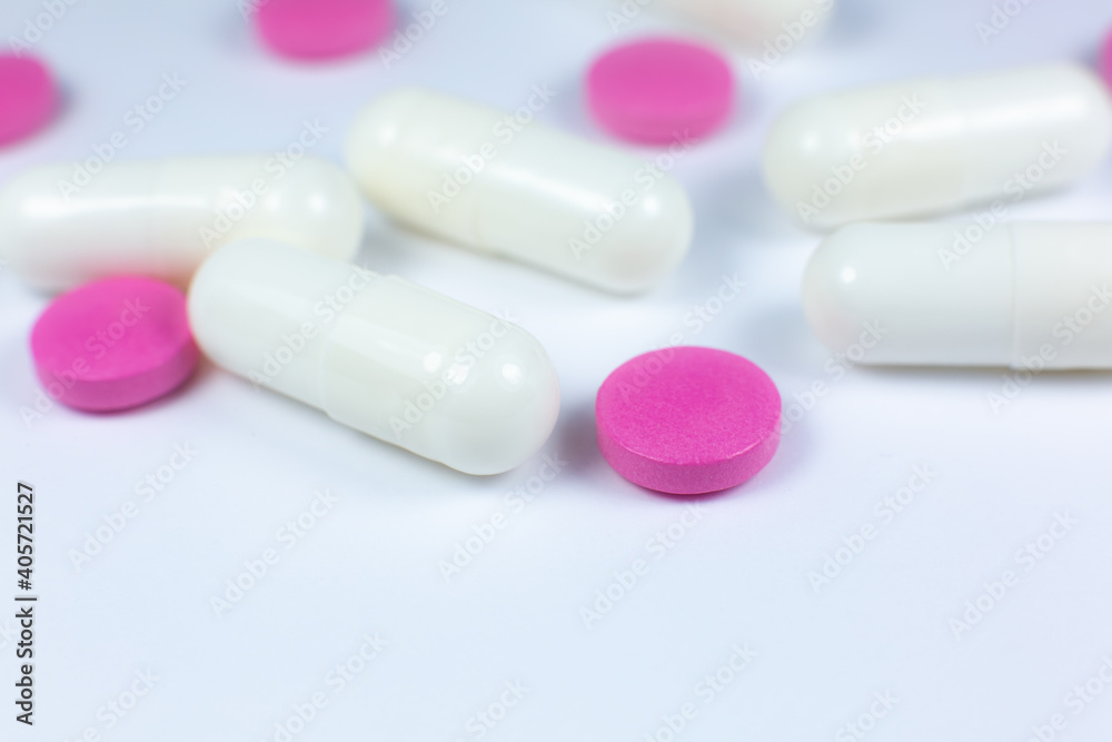 Colored pills on white background. Close up. Medical treatment concept. Colored pills on white background. Close up. Medical treatment concept.