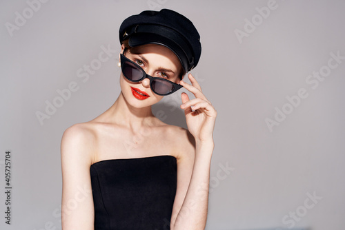 Pretty woman fashionable clothes dark glasses red lips evening dress