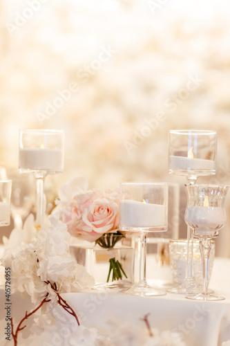 Candles background. White candles in the candlestick and roses with the place for your text