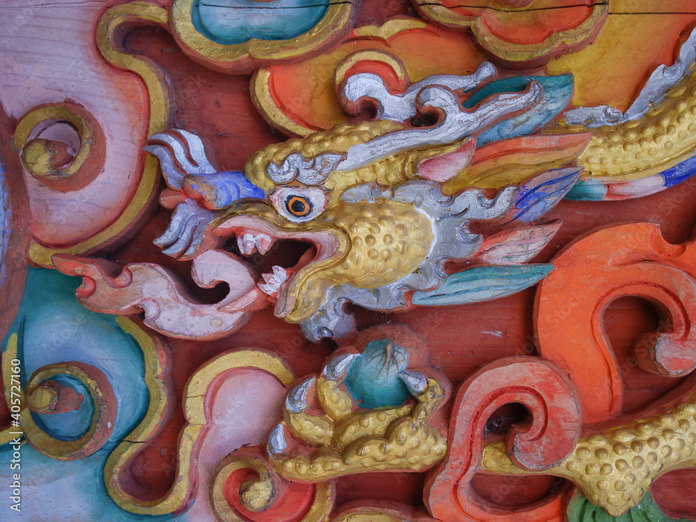 Beautiful colorful traditional bhutanese woodcarving of a dragon in Zangdkok Palri lhakang near Kurjey in Bumthang valley, Bhutan Beautiful colorful traditional bhutanese woodcarving of a dragon in Zangdkok Palri lhakang near Kurjey in Bumthang valley, Bhutan
