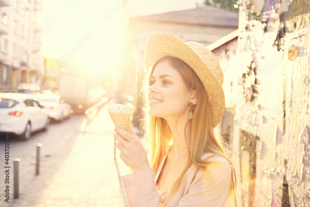 Cheerful woman in hat eating ice cream walk outdoor sun