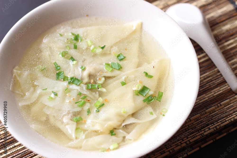 a bowl of dumplings with sweet clear chicken broth a bowl of dumplings with sweet clear chicken broth