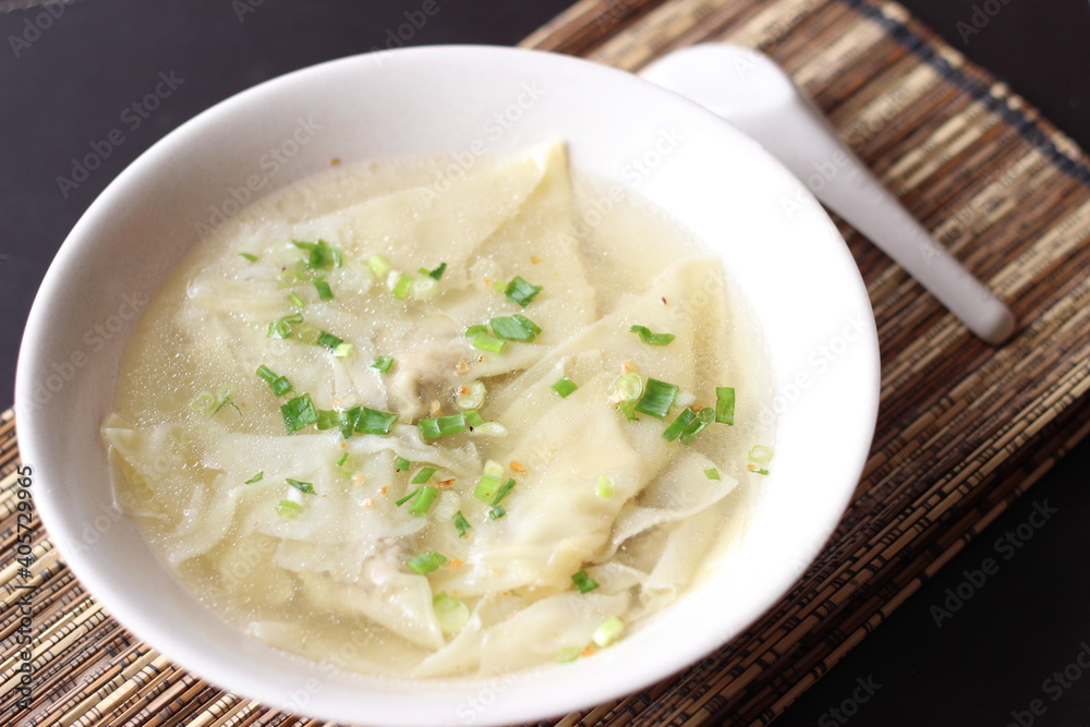 a bowl of dumplings with sweet clear chicken broth