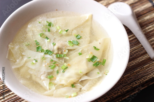 a bowl of dumplings with sweet clear chicken broth