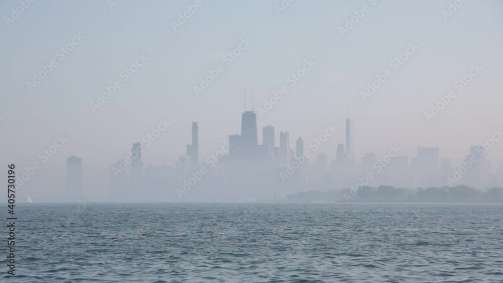 Video of downtown Chicago skyline from a far distance with smog and fog covering the buildings. Video of downtown Chicago skyline from a far distance with smog and fog covering the buildings.