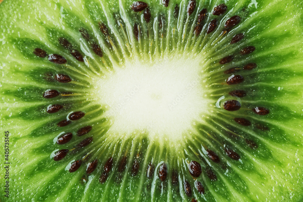 Slice of ripe kiwi fruit in full screen close-up. Slice of ripe kiwi fruit in full screen close-up.
