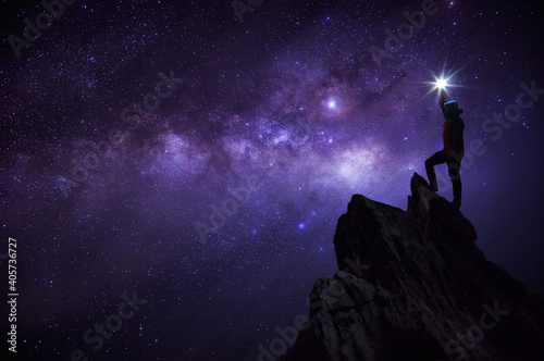 Man Standing On Rock Against Sky At Night