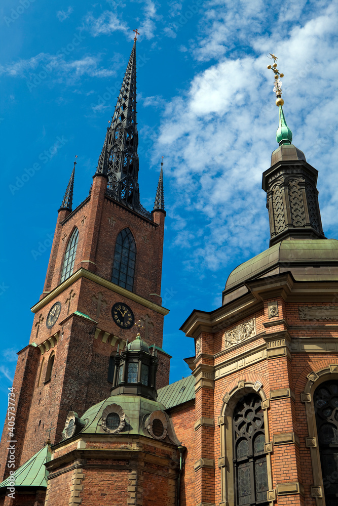 Low angle view of Riddarholmskyrkan (Church of Riddarholmen, Stockholm, Sweden) Summer day, blue cloudy sky.