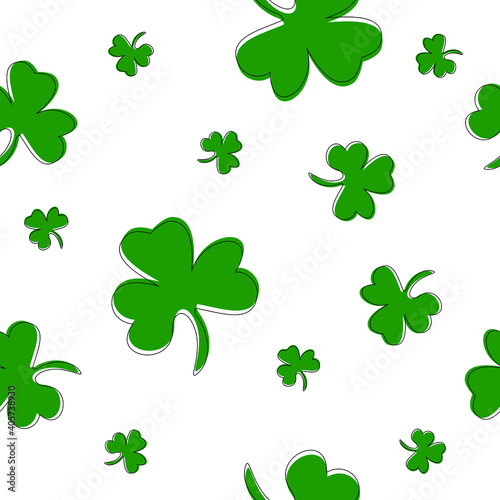Festive seamless pattern for Saint Patrick's Day. Green leaves of clover scattered on white randomly.