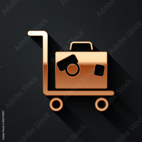 Gold Hotel luggage cart with suitcase icon isolated on black background. Traveling baggage sign. Travel luggage icon. Long shadow style. Vector.