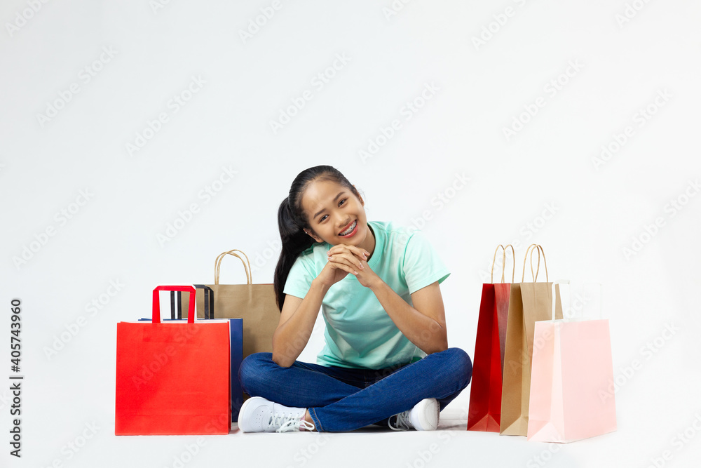 Young asia girl with lot of shopping bags looking down with the hand on the chin
Young asia girl with lot of shopping bags looking down with the hand on the chin