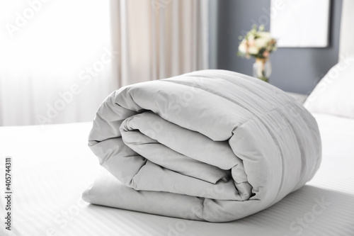 Soft folded blanket on bed at home