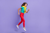 Full length body size view of pretty skinny cheerful wavy-haired girl jumping running isolated over violet pastel color background