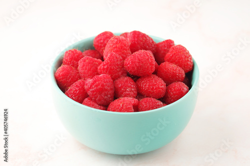 A bowl with ripe bright raspberries