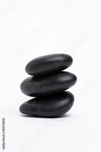 Zen concept: stones arranged against white background