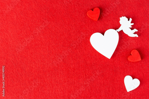 Hearts and Cupid on red felt background for Valentine day  wedding or dating